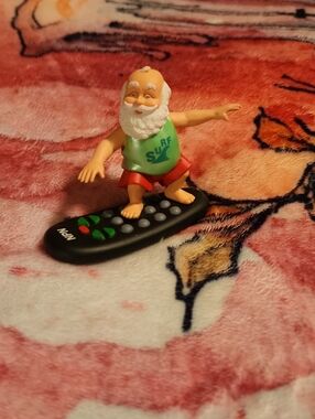 Surf Santa Figurine on Remote - Green Top, Red Shorts